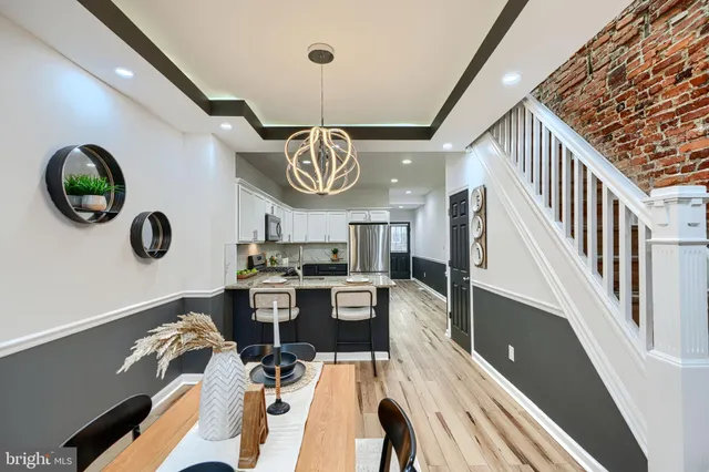 a view of a dining room with furniture and chandelier