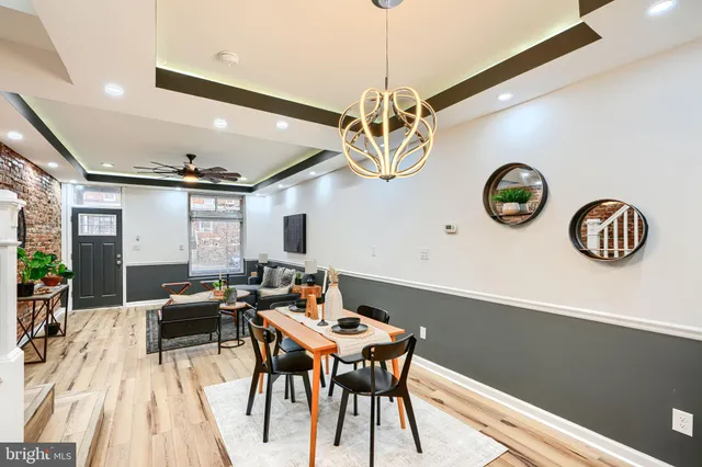 a view of a dining room with furniture wooden floor and a chandelier
