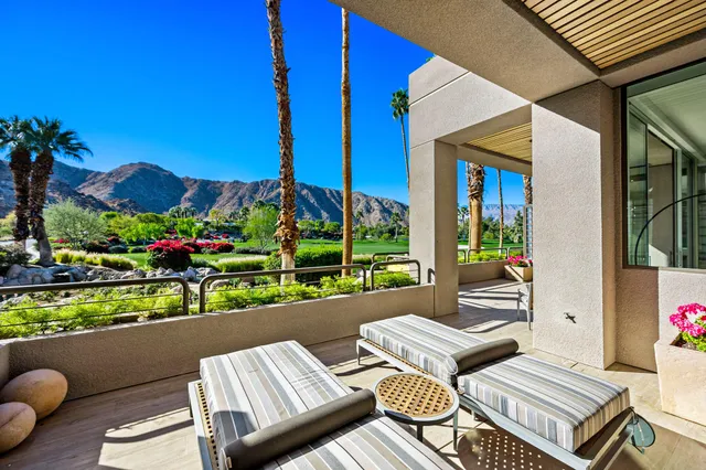 a view of a patio with couches table and chairs and potted plants