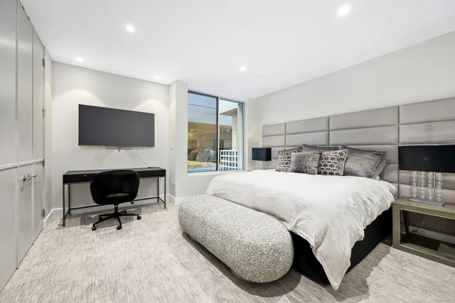 a bedroom with a bed and a flat screen tv