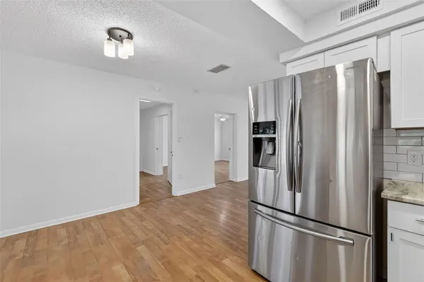 a metallic refrigerator freezer sitting in a kitchen