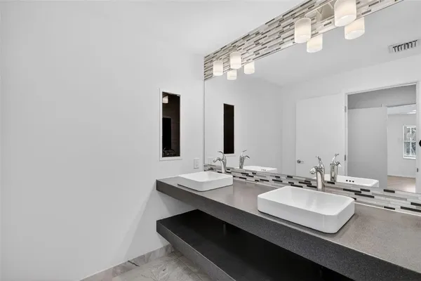 a bathroom with a sink a mirror and a vanity