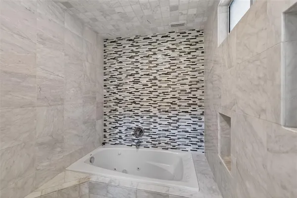 a bathroom with a bathtub and shower