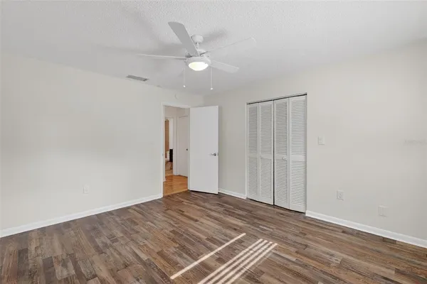 a view of an empty room with wooden floor