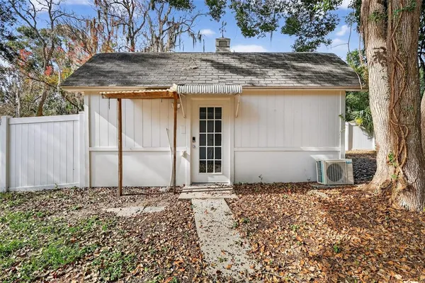 an empty room with windows and painted walls