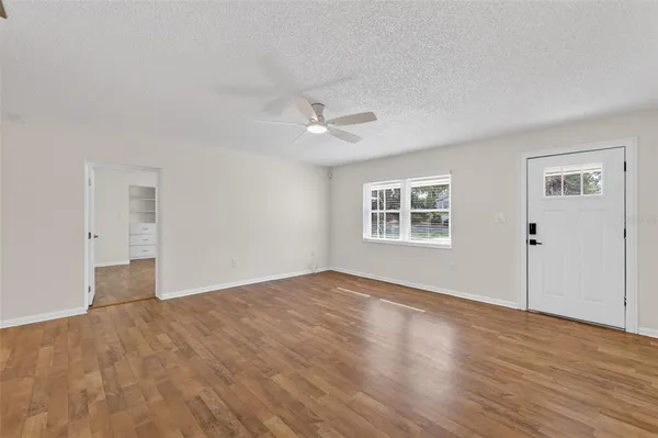 wooden floor in an empty room with a window