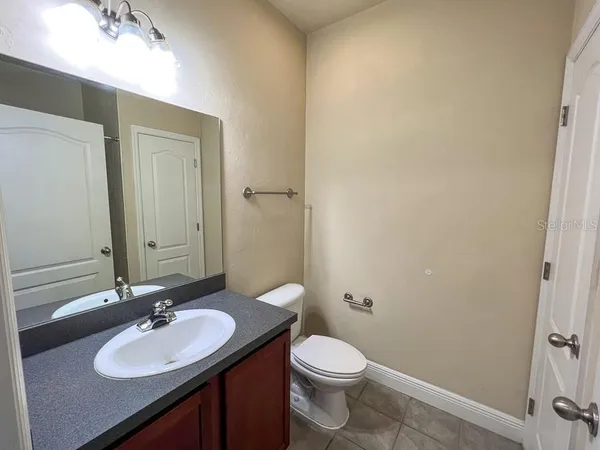 a bathroom with a sink a toilet and mirror