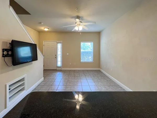 a view of a livingroom with furniture flat screen tv and window