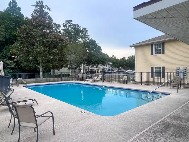 a view of a swimming pool with chairs