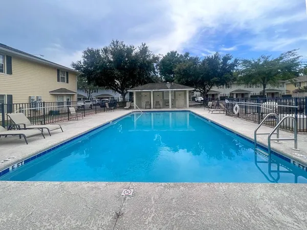 a view of a swimming pool with outdoor seating