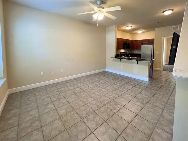 a view of kitchen with stainless steel appliances a refrigerator and a stove top oven