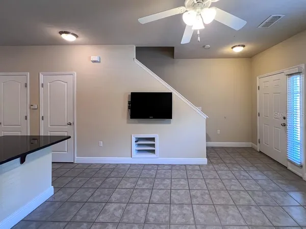 a view of a livingroom with an empty space and a kitchen space