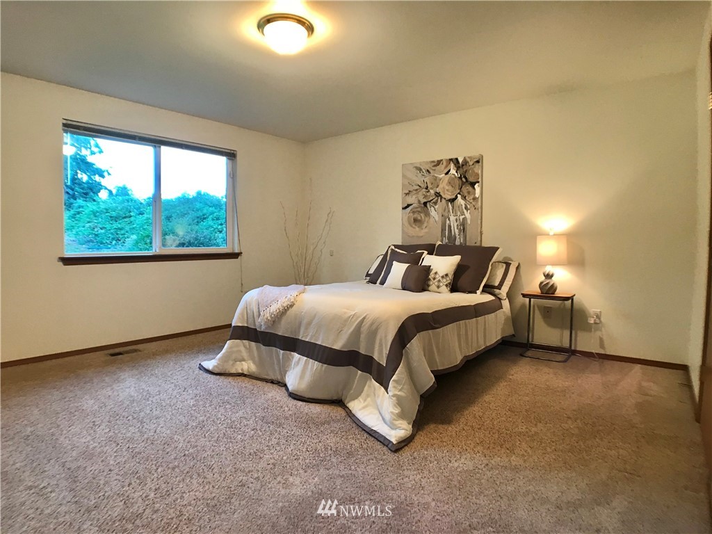6018 Prather Road Southwest Centralia, WA 98531 - Photo 19 of 28 a spacious bedroom with a bed and a window