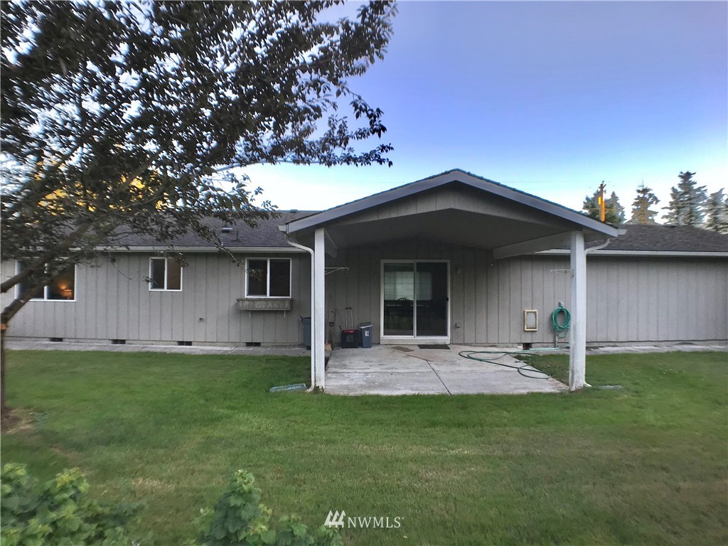 6018 Prather Road Southwest Centralia, WA 98531 - Photo 10 of 28 a front view of a house with a garden and trees