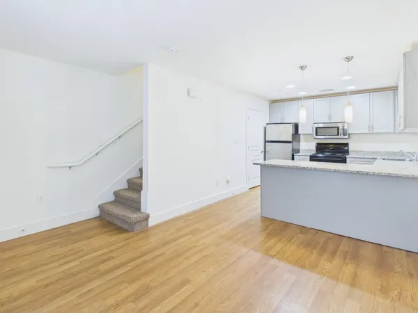 a view of kitchen with wooden floor and electronic appliances