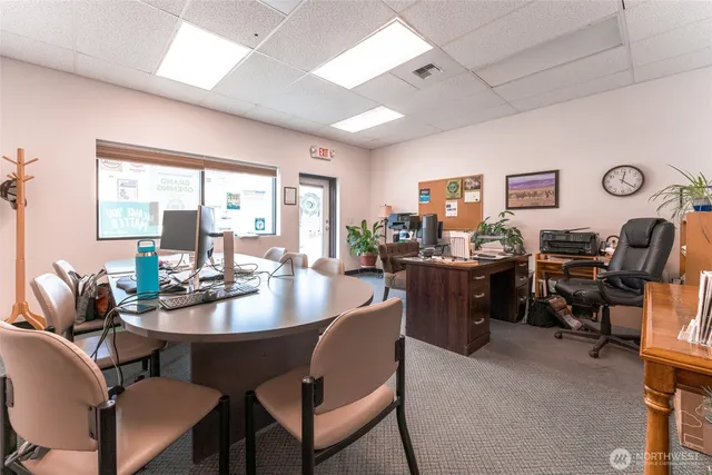 a view of a dining room with furniture and a large window