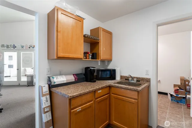 a kitchen with a stove a sink and a microwave