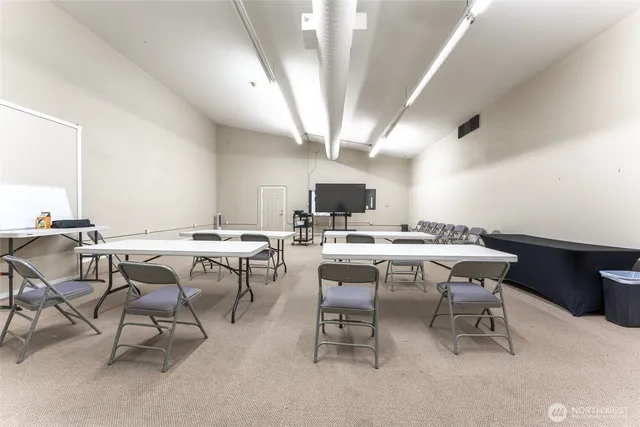 a view of a big room with table and chairs