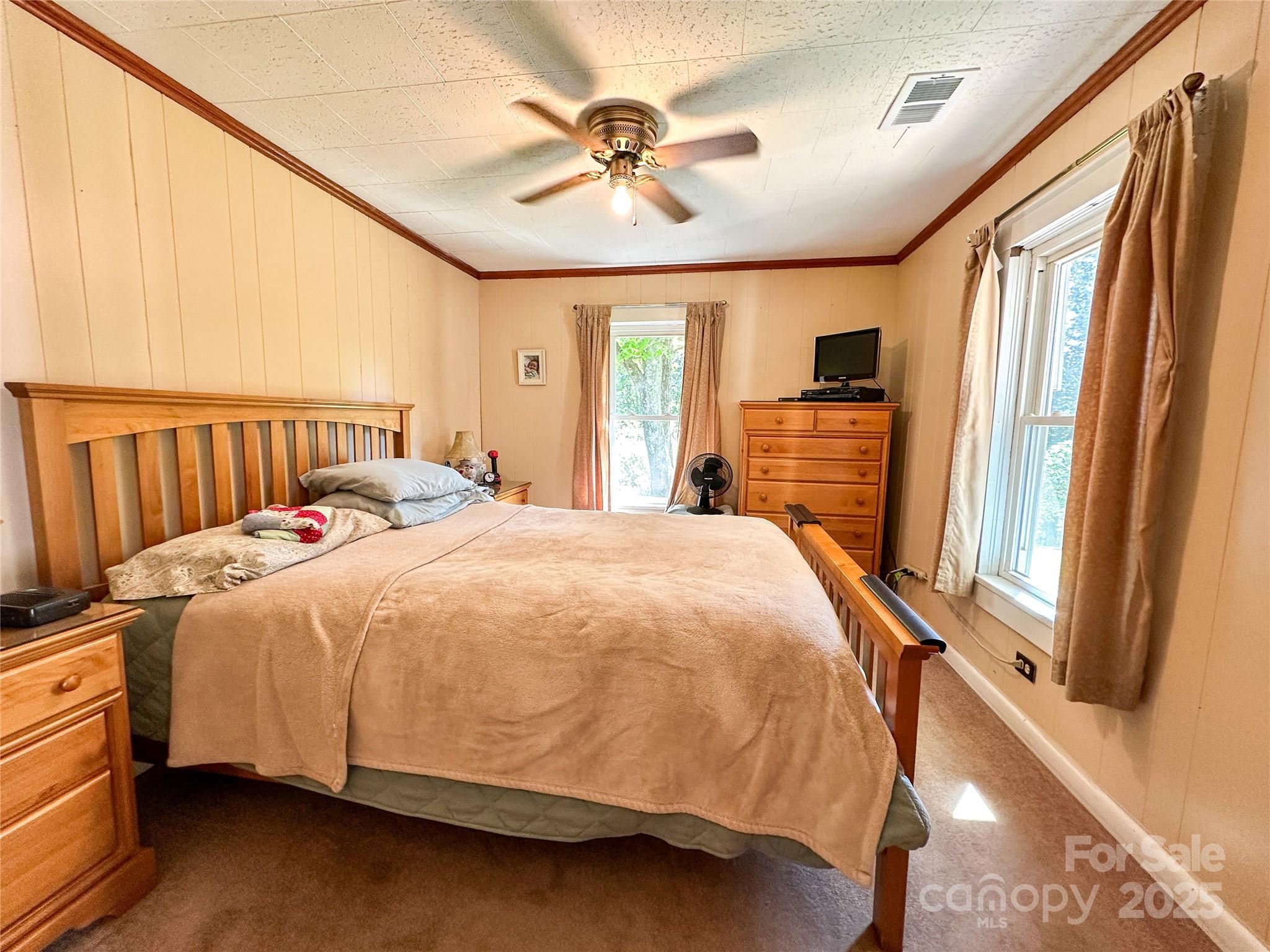 241 Canada Road Tuckasegee, NC 28783 - Photo 11 of 27 a large bed sitting in a bedroom next to a window