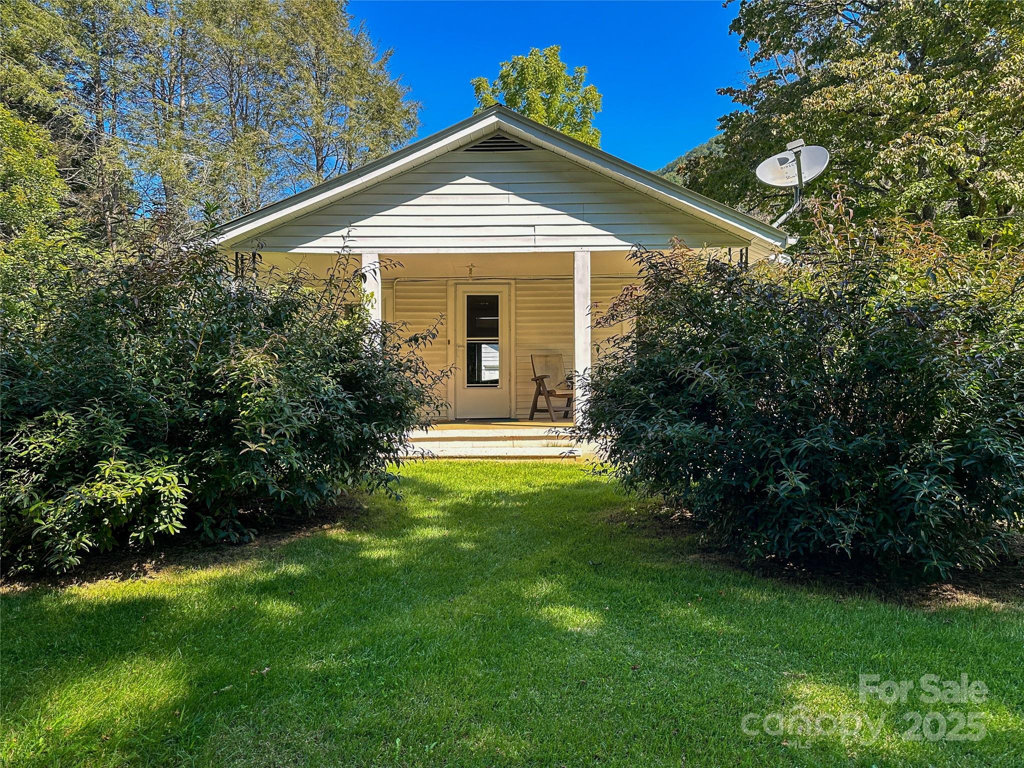 241 Canada Road Tuckasegee, NC 28783 - Photo 15 of 27 a front view of a house with a garden