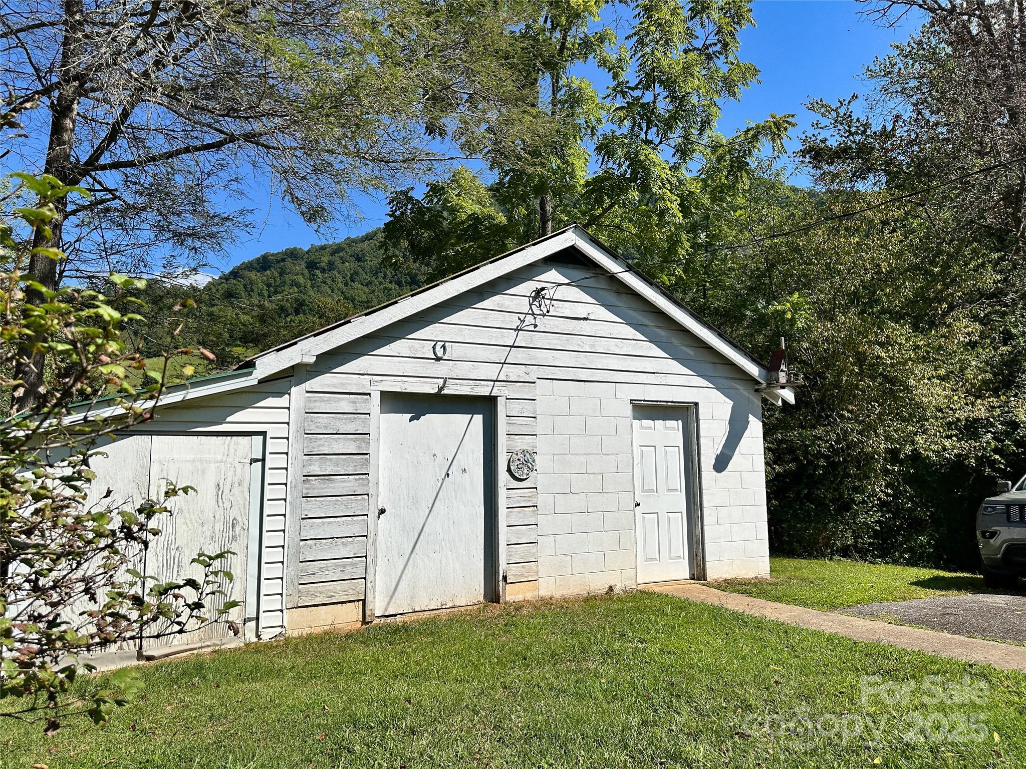 241 Canada Road Tuckasegee, NC 28783 - Photo 19 of 27 a view of a house with a yard