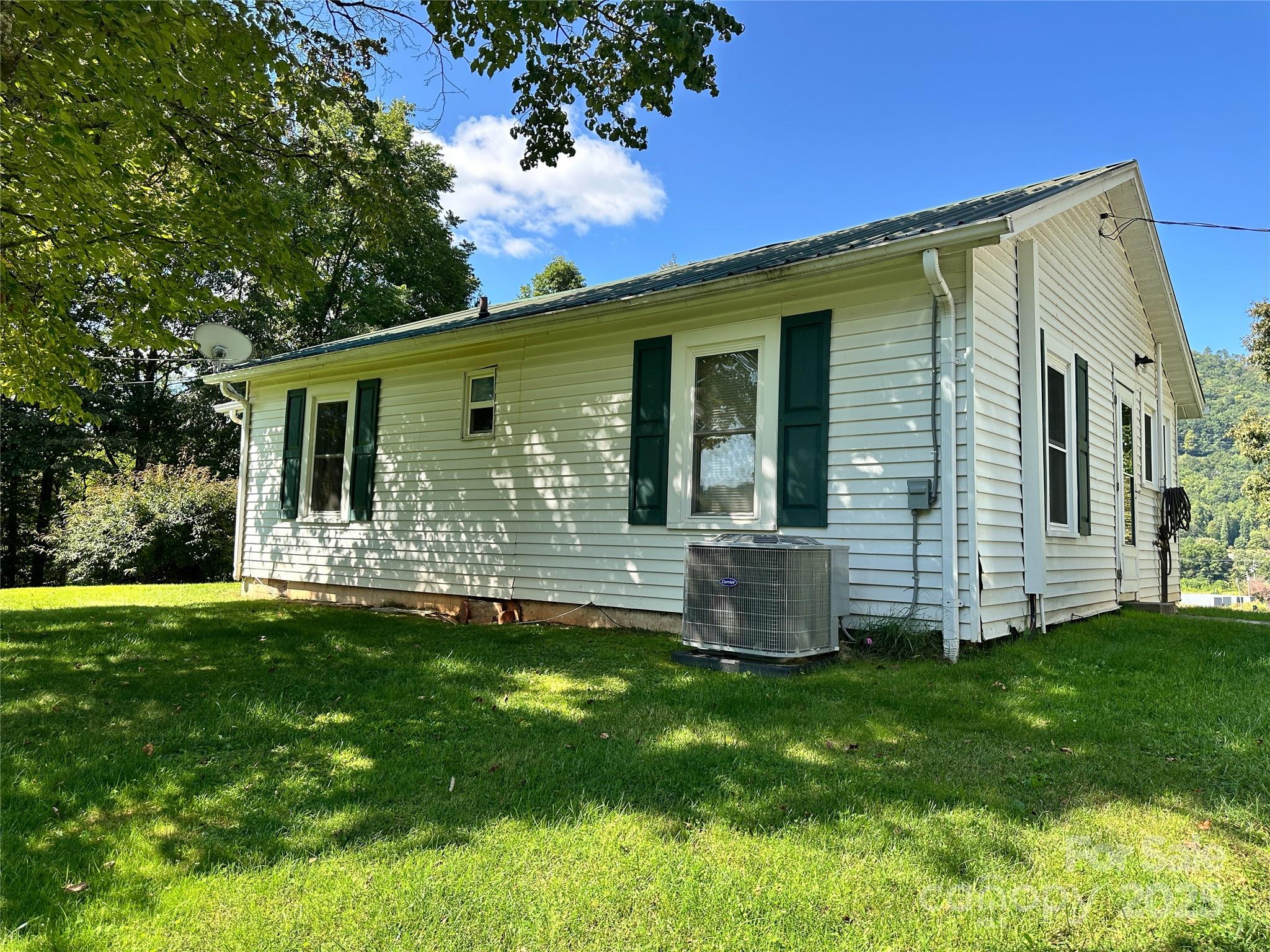 241 Canada Road Tuckasegee, NC 28783 - Photo 4 of 27 a view of a house with backyard and sitting area