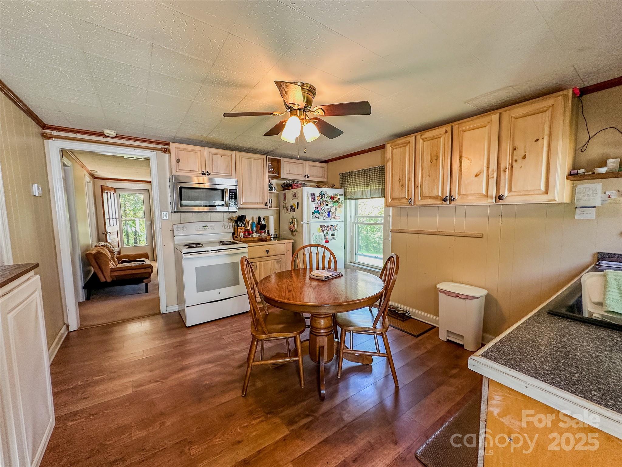 241 Canada Road Tuckasegee, NC 28783 - Photo 7 of 27 a view of a dining room with furniture and a chandelier