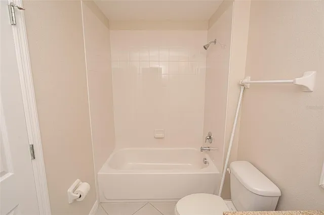 a bathroom with a toilet and a bath tub
