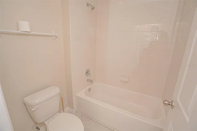 a white bath tub sitting next to a toilet