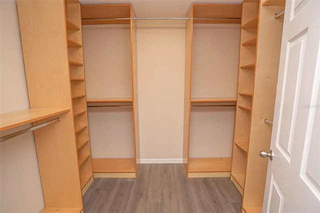 a view of walk in closet with empty racks