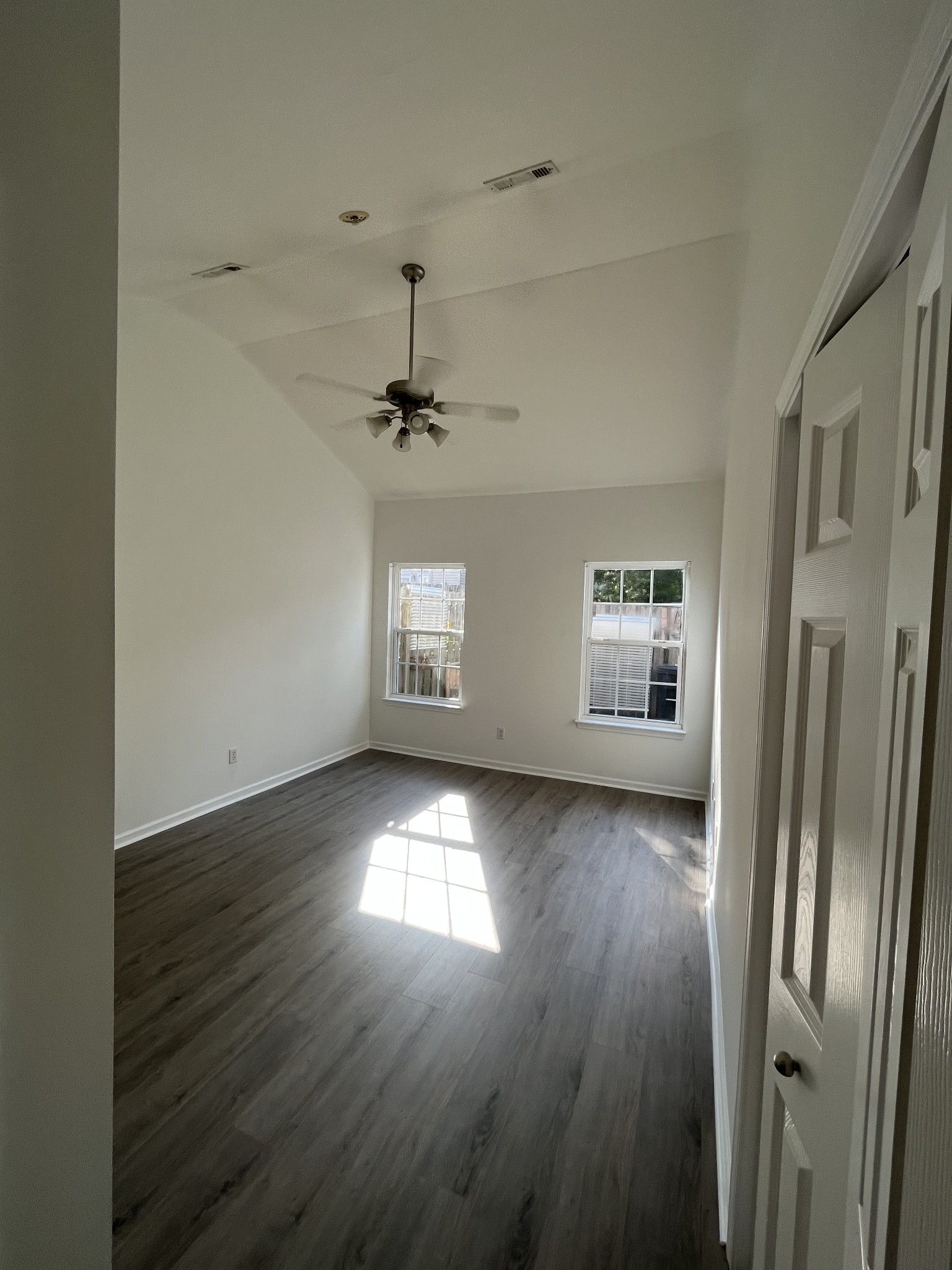 1101 Downs Boulevard, Unit 106 Franklin, TN 37064 - Photo 11 of 11 a view of a livingroom with wooden floor a ceiling fan and windows