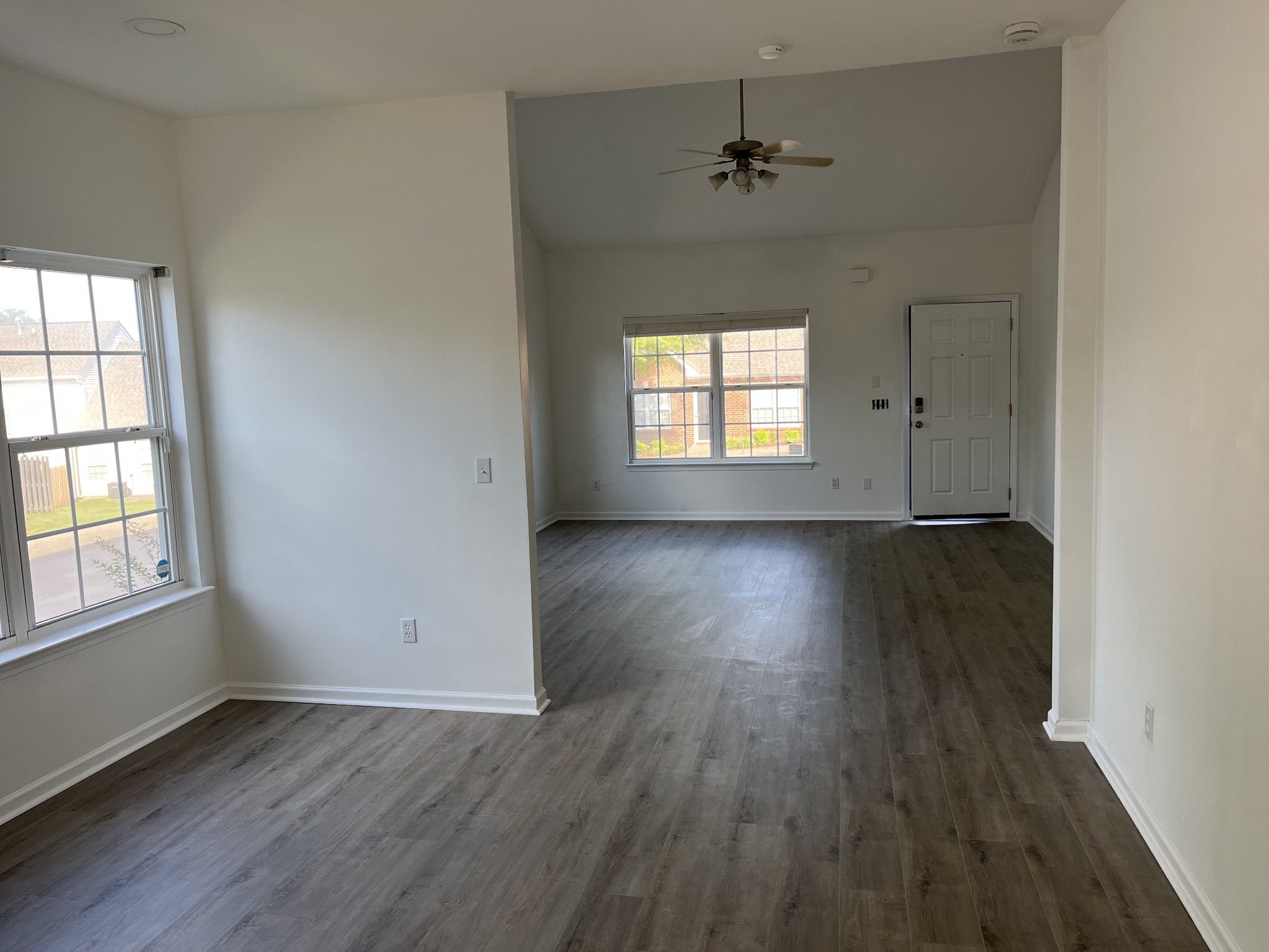 1101 Downs Boulevard, Unit 106 Franklin, TN 37064 - Photo 5 of 11 an empty room with wooden floor and windows