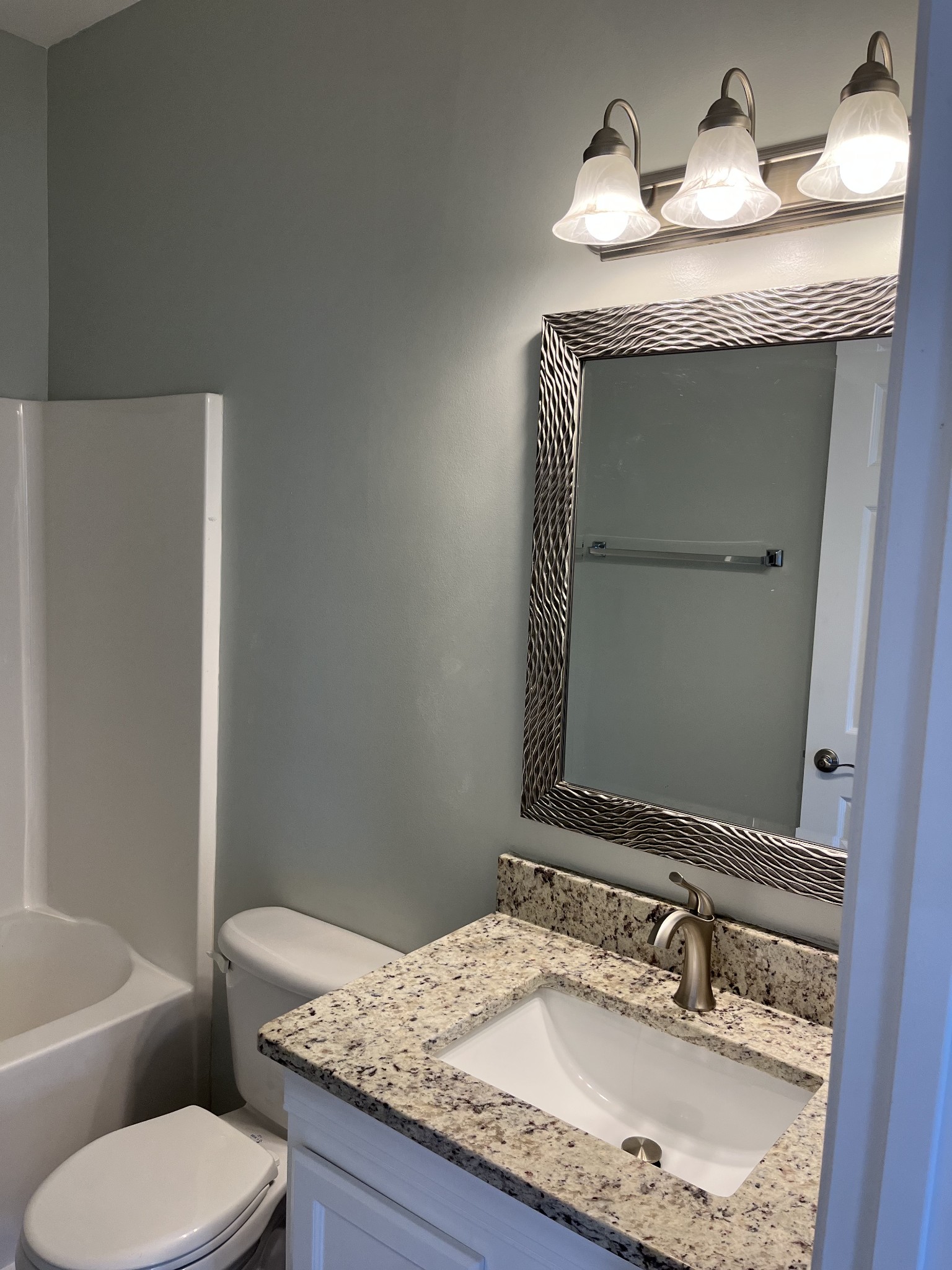 1101 Downs Boulevard, Unit 106 Franklin, TN 37064 - Photo 8 of 11 a bathroom with a granite countertop sink and a toilet