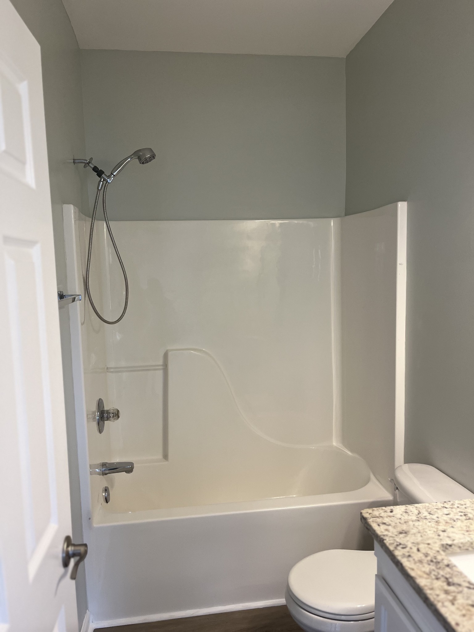 1101 Downs Boulevard, Unit 106 Franklin, TN 37064 - Photo 9 of 11 a bathroom with a granite countertop bathtub shower and toilet