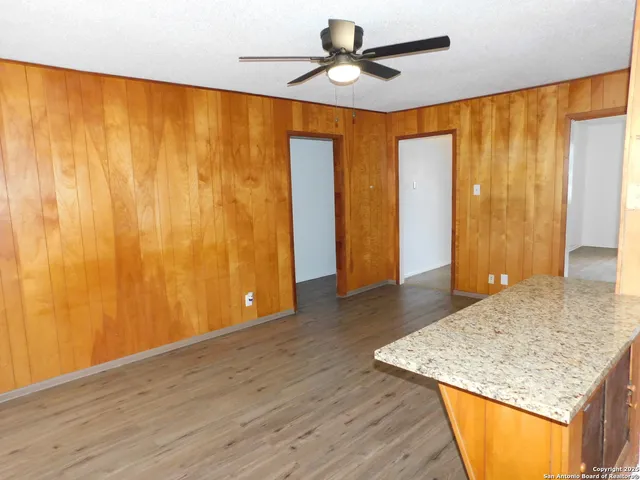 a view of a room with wooden floor and natural light
