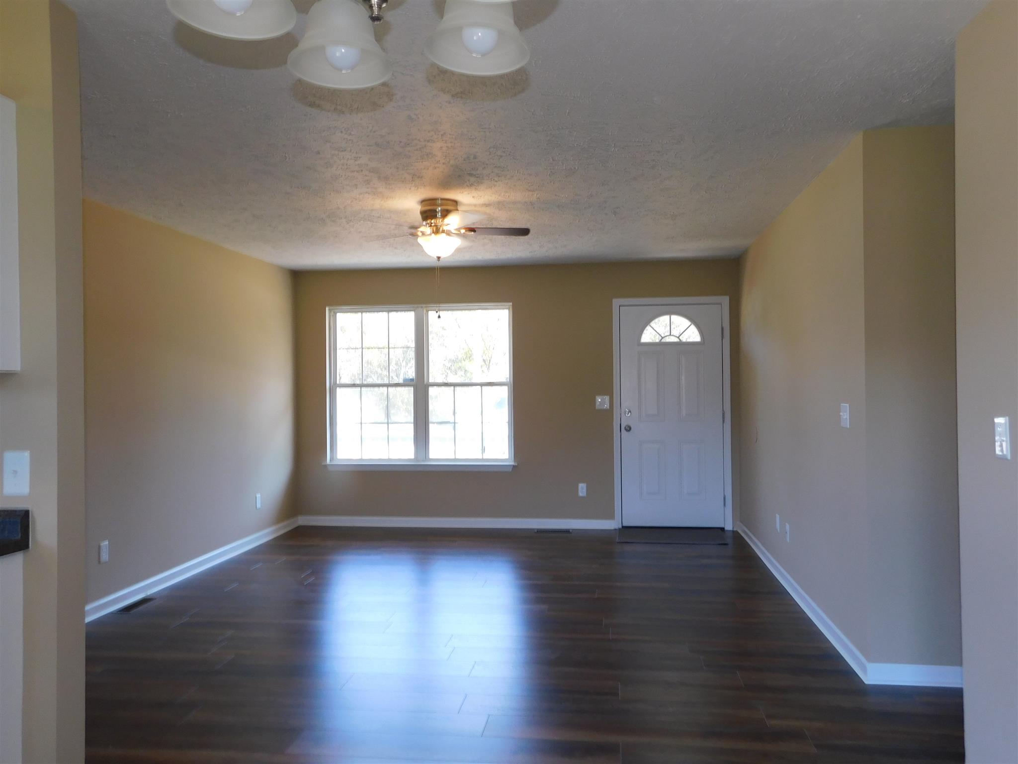 125 Rodeo Drive Columbia, TN 38401 - Photo 2 of 13 View of large LR & Dining Area with all new flooring, new ceiling fan, new doors and all walls, ceilings & trim repainted.