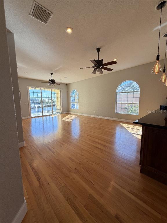 808 Symphony Isles Boulevard Apollo Beach, FL 33572 - Photo 16 of 50 a view of empty room with wooden floor and fan