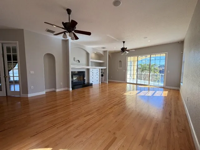 a view of a livingroom with a fireplace and a ceiling fan