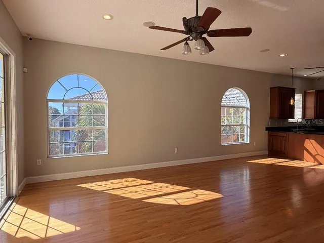 a kitchen with granite countertop a refrigerator stove top oven and sink