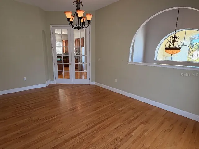 a view of a room with wooden floor