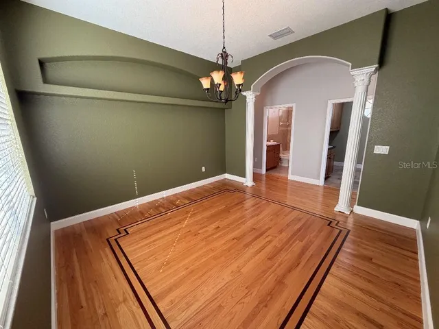 a view of a room with a wooden floor