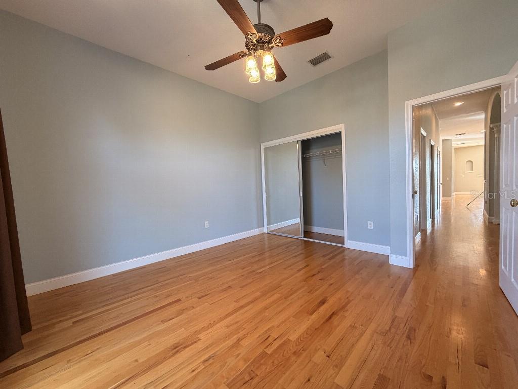 808 Symphony Isles Boulevard Apollo Beach, FL 33572 - Photo 36 of 50 wooden floor in an empty room with a window