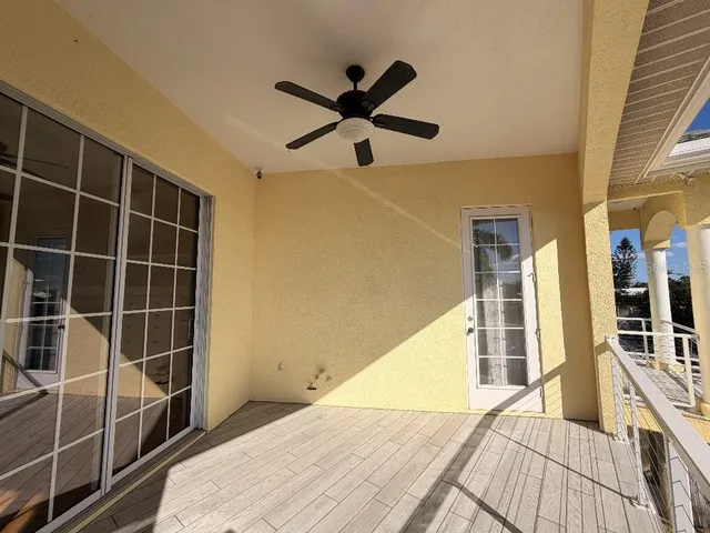 a view of a room with wooden floor and windows