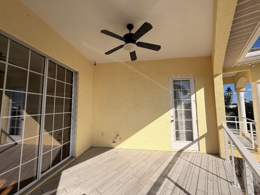 808 Symphony Isles Boulevard Apollo Beach, FL 33572 - Photo 6 of 50 a view of a room with wooden floor and windows