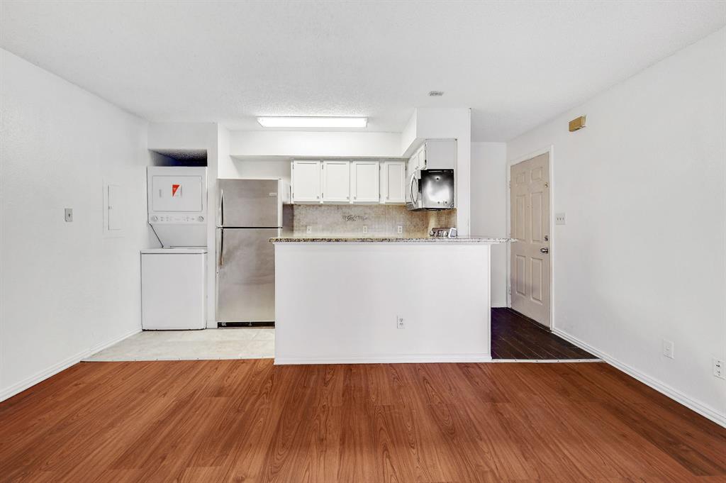a kitchen with wooden floors and white appliances