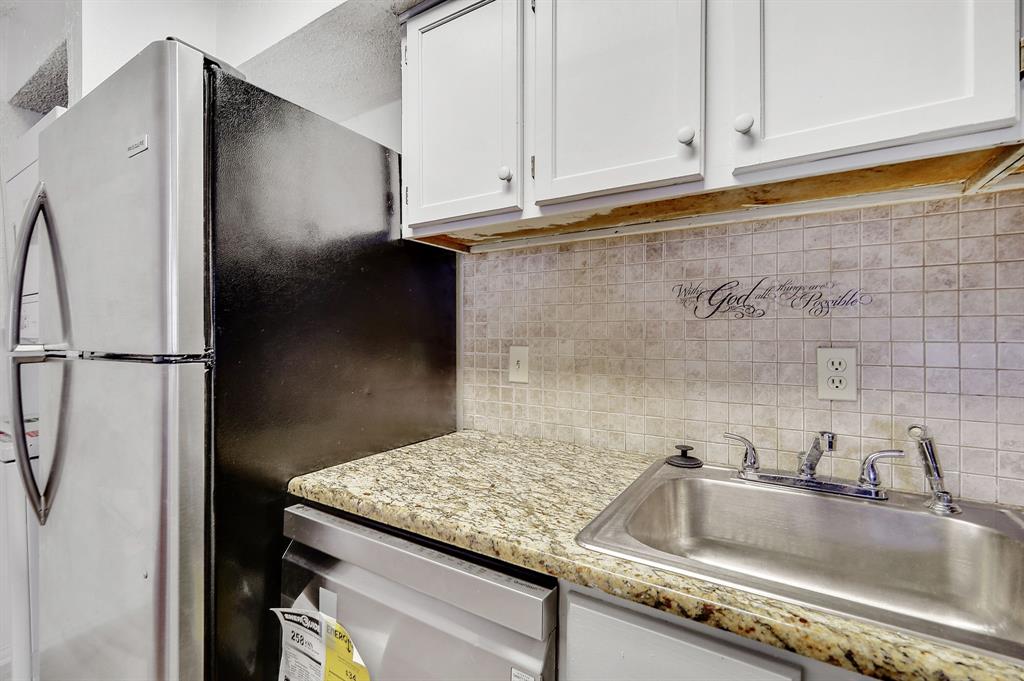 9823 Walnut Street, Unit 304 Dallas, TX 75243 - Photo 11 of 26 a kitchen with granite countertop a sink and a refrigerator