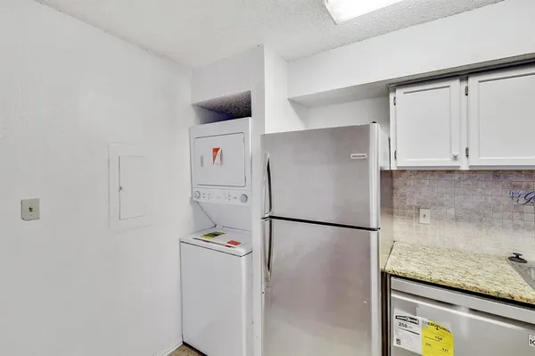 a kitchen with a refrigerator and cabinets
