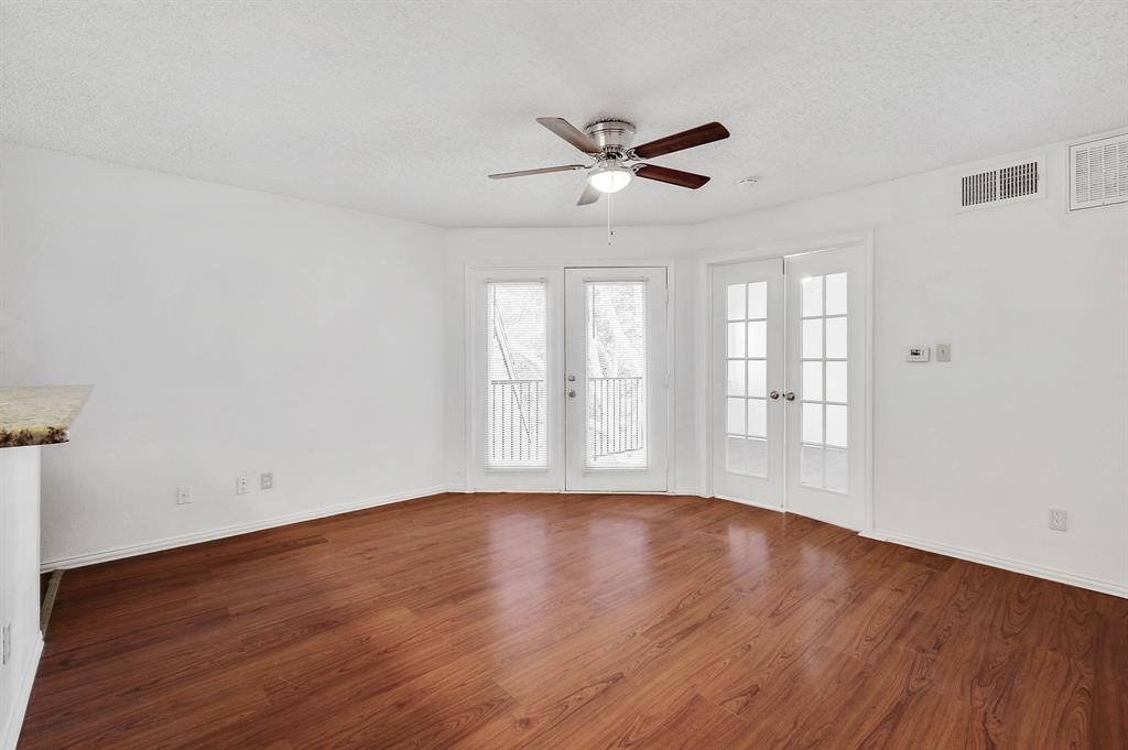 9823 Walnut Street, Unit 304 Dallas, TX 75243 - Photo 17 of 26 a view of an empty room with wooden floor and a window