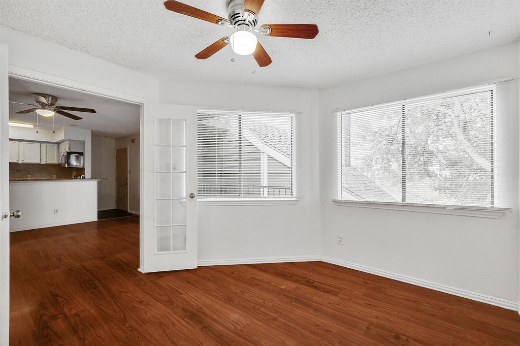 9823 Walnut Street, Unit 304 Dallas, TX 75243 - Photo 2 of 26 a view of empty room with wooden floor and fan