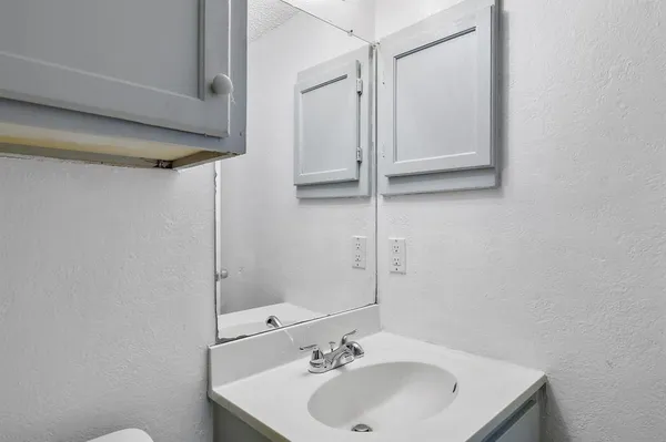 a bathroom with a sink and shower